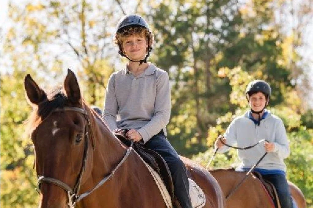 student smiling on horse