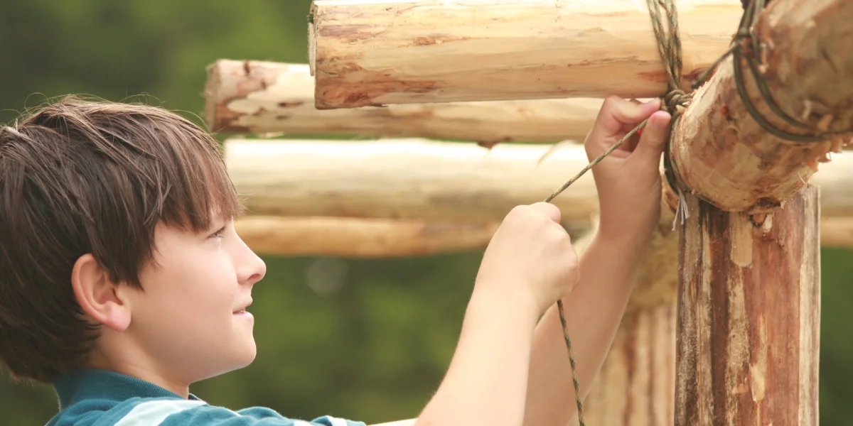 student lashing wood