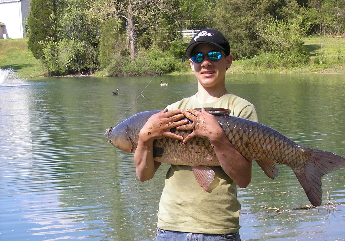 student holding large fish