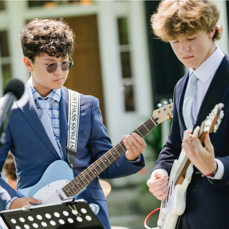 two students playing guitar