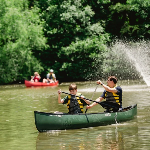 students and teachers canoeing in the lake