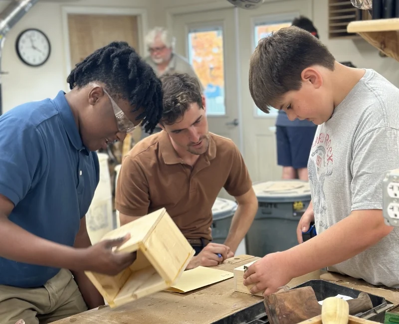 teacher and 2 students in woodshop class