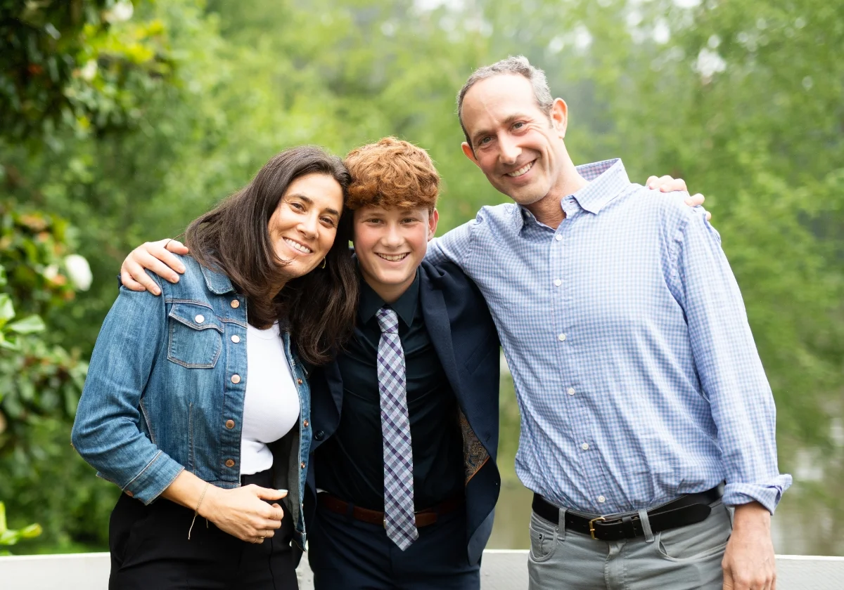 student smiling with parents