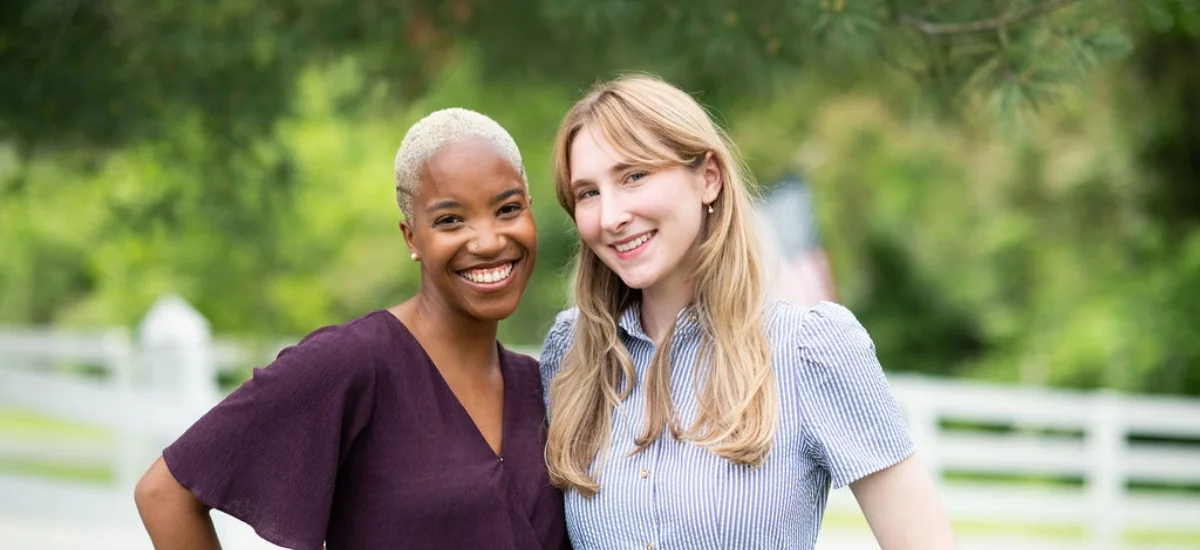 two female employees smiling